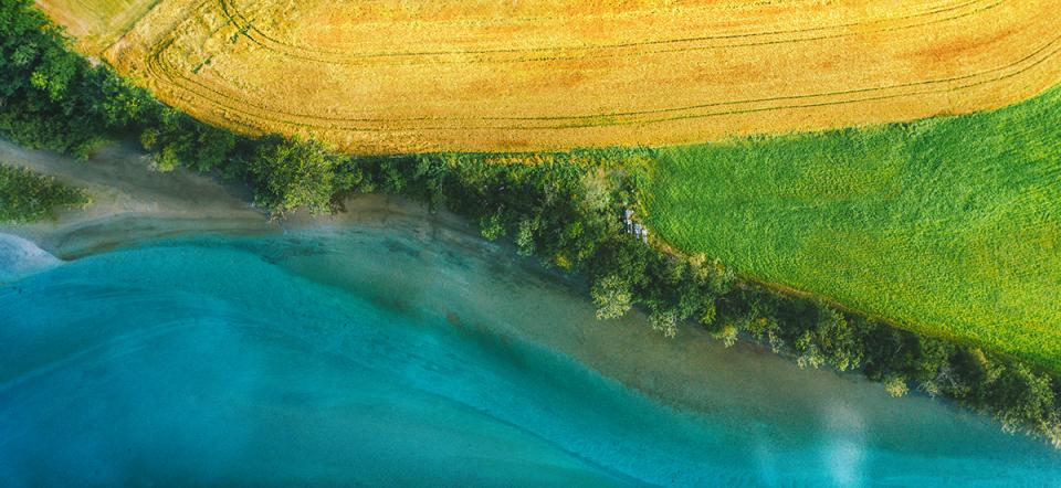 Aerial view over landscape with river and farmland 