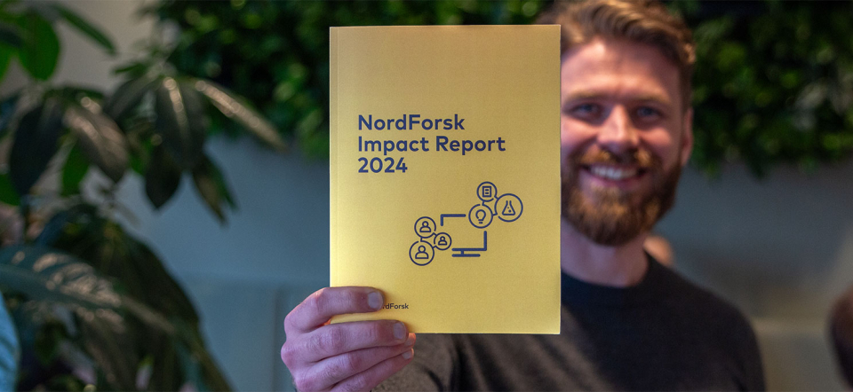 A happy man holding the NordForsk Impact Report