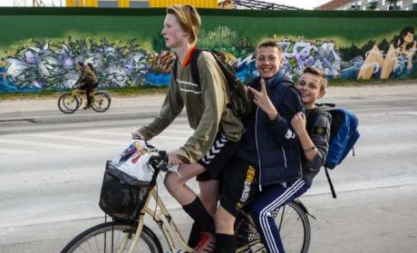 Tre drenge på en cykel