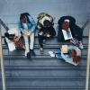 Young people sitting in stairs at school