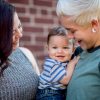 Two women holding a child.