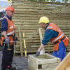 Two senior carpenters working outside