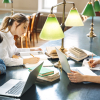 Three people studying in a library